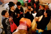 Discussing which shawls (mantas) to select, cholita fashion show, El Alto, La Paz.