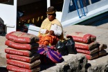 Cholita waiting for a boat, Copacabana, Lake Titicaca, Bolivia.