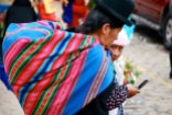 Many indigenous Bolivian women carry a cloth filled with goods on their back.