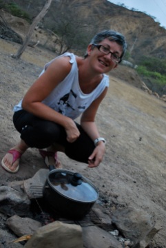 Cooking goat stew over hot coals, Zorritos, Peru